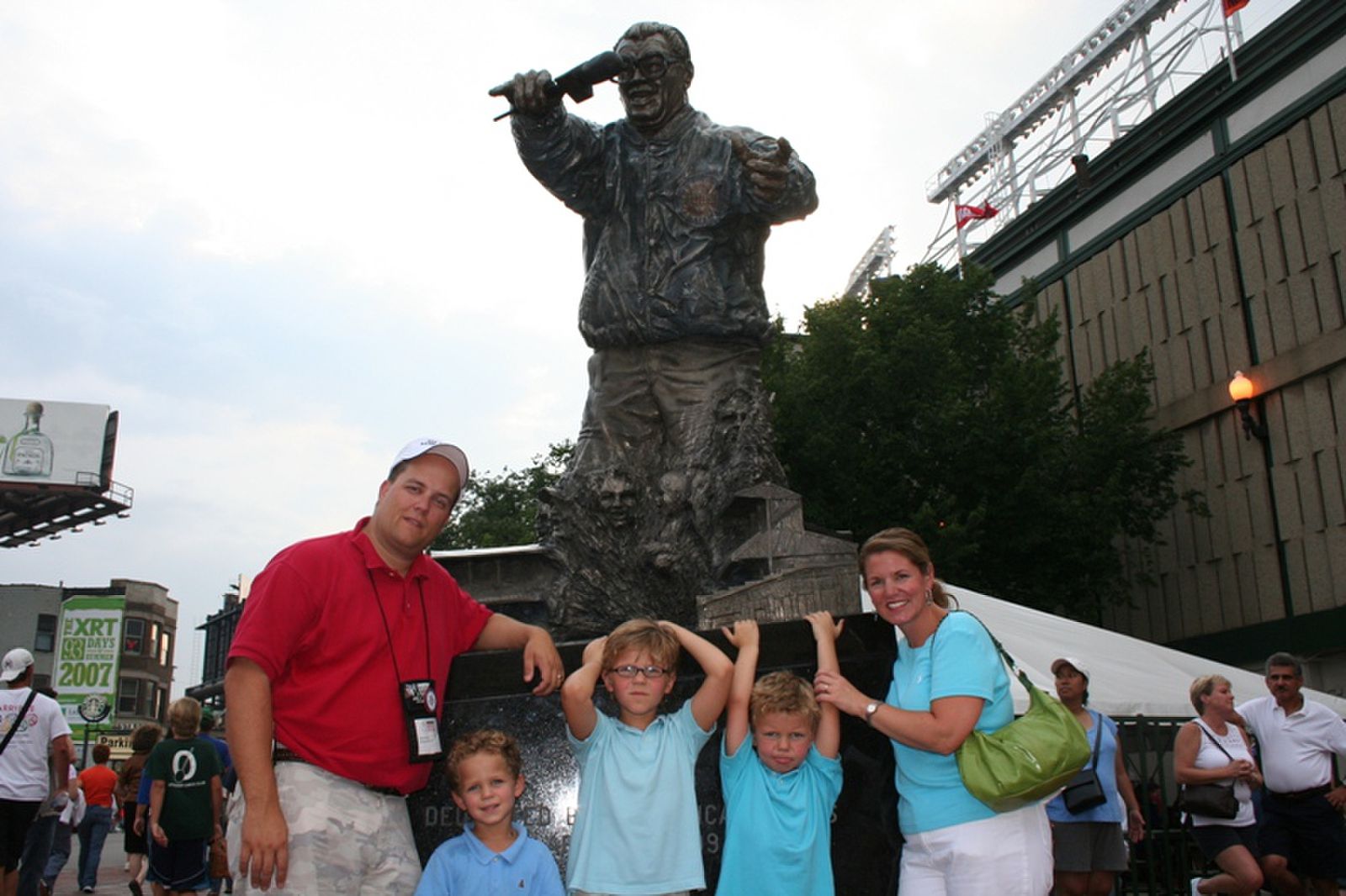 The Fedjes pose in front of the Harry Caray statue